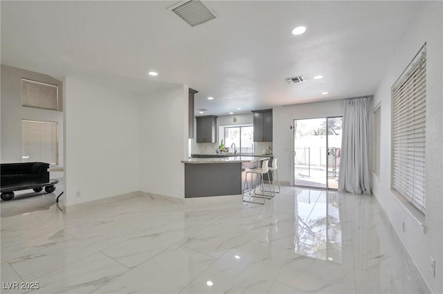 8404 Shore Breeze Dr, Las Vegas, NV 89128 - living room with light marble finish flooring, recessed lighting, and baseboards