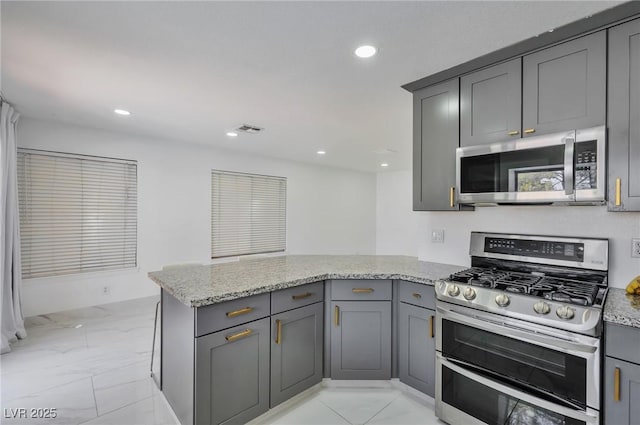 8404 Shore Breeze Dr, Las Vegas, NV 89128 - kitchen featuring stainless steel appliances, gray cabinets, a peninsula, light marble finish floors, and recessed lighting