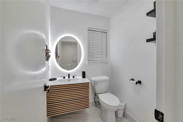 8404 Shore Breeze Dr, Las Vegas, NV 89128 - bathroom with marble finish floors, toilet, vanity, and baseboards