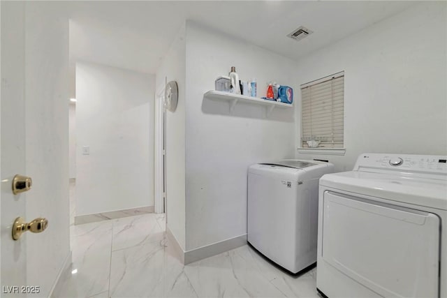 8404 Shore Breeze Dr, Las Vegas, NV 89128 - laundry area featuring washing machine and clothes dryer, light marble finish floors, and baseboards