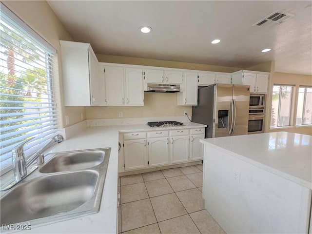 7840 Millhopper Ave, Las Vegas, NV 89128 - kitchen with a sink, under cabinet range hood, stainless steel appliances, white cabinets, and light tile patterned floors