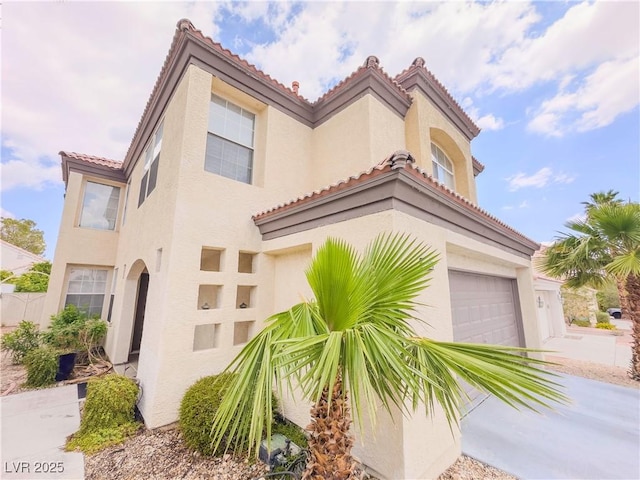 7840 Millhopper Ave, Las Vegas, NV 89128 - mediterranean / spanish house with stucco siding, a tiled roof, an attached garage, and driveway