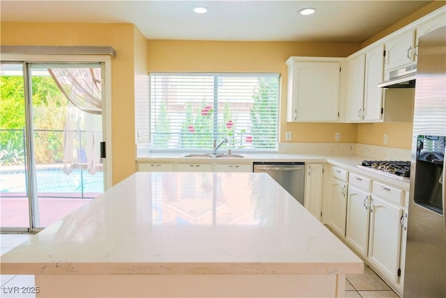 7840 Millhopper Ave, Las Vegas, NV 89128 - kitchen with stainless steel appliances, a sink, under cabinet range hood, recessed lighting, and a center island