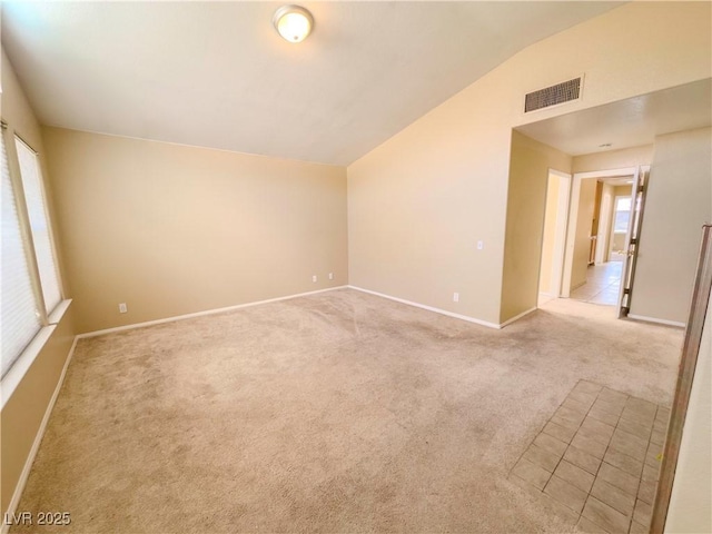 7840 Millhopper Ave, Las Vegas, NV 89128 - unfurnished room featuring vaulted ceiling, light colored carpet, and baseboards