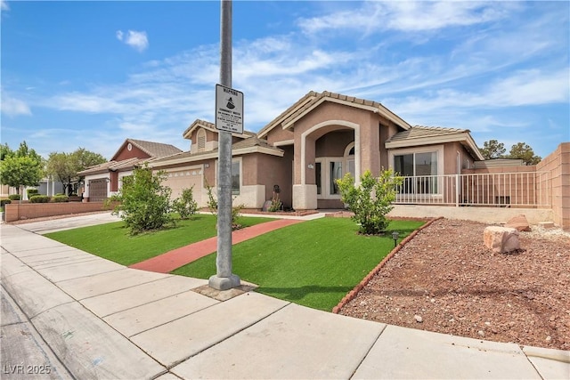4537 Colonial Canyon St, North Las Vegas, NV 89031 - view of front of house with an attached garage, a tiled roof, stucco siding, concrete driveway, and a front lawn