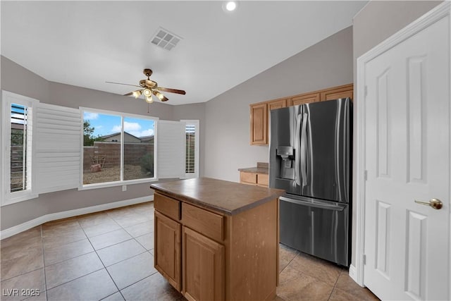 kitchen featuring ceiling fan, light tile patterned flooring, stainless steel fridge with ice dispenser, and dark countertops