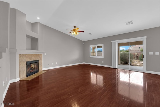 unfurnished living room with wood finished floors, a ceiling fan, visible vents, baseboards, and vaulted ceiling