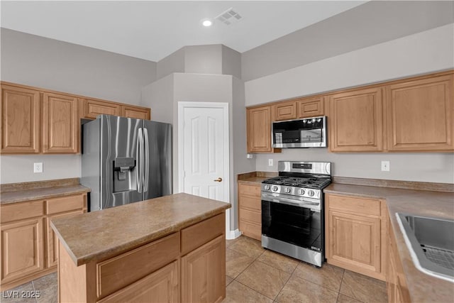 kitchen featuring light brown cabinetry, light tile patterned flooring, visible vents, a sink, and appliances with stainless steel finishes