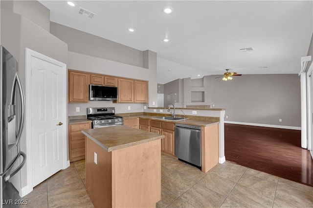 kitchen featuring a ceiling fan, lofted ceiling, visible vents, a sink, and appliances with stainless steel finishes