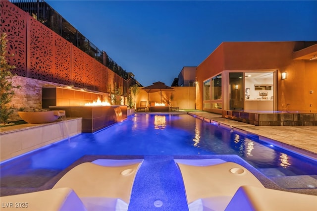 819 Bolide St, Las Vegas, NV 89138 - pool at twilight with a patio, fence, and a hot tub