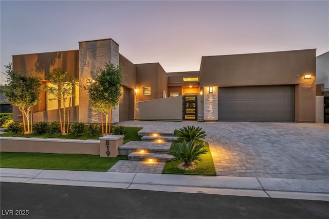 819 Bolide St, Las Vegas, NV 89138 - view of front of home with a garage, stucco siding, and decorative driveway