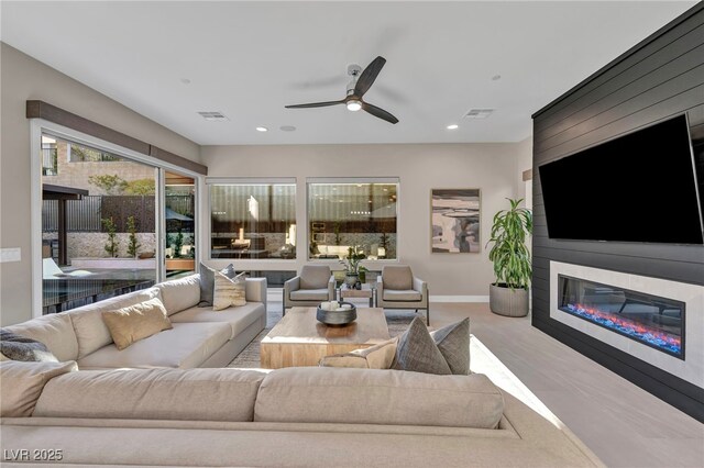 819 Bolide St, Las Vegas, NV 89138 - living room with a glass covered fireplace, a ceiling fan, baseboards, and recessed lighting
