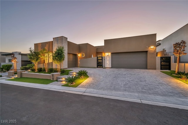 819 Bolide St, Las Vegas, NV 89138 - view of front of property with an attached garage, stucco siding, and decorative driveway