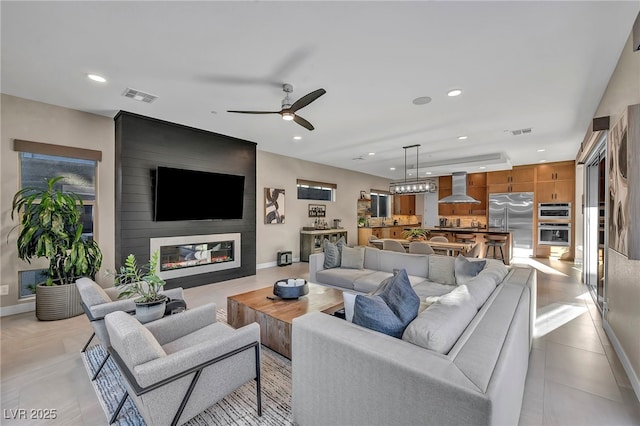 819 Bolide St, Las Vegas, NV 89138 - living area featuring a ceiling fan, a large fireplace, recessed lighting, and baseboards