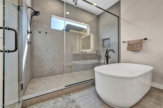 819 Bolide St, Las Vegas, NV 89138 - full bathroom with a shower stall, a soaking tub, and tile patterned flooring