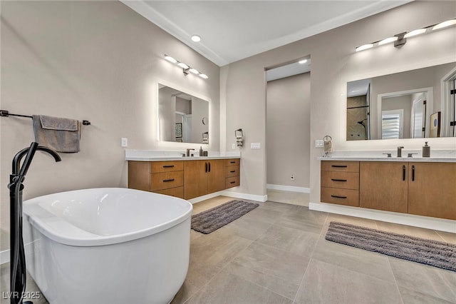 819 Bolide St, Las Vegas, NV 89138 - bathroom with two vanities, a freestanding bath, and baseboards