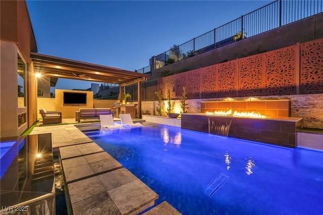 819 Bolide St, Las Vegas, NV 89138 - view of swimming pool featuring a patio, a warm lit fireplace, and fence
