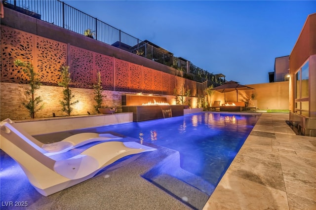 819 Bolide St, Las Vegas, NV 89138 - pool at night featuring a patio area