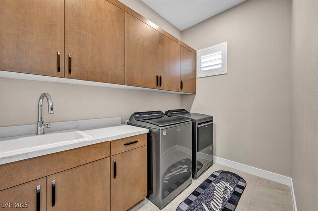 819 Bolide St, Las Vegas, NV 89138 - laundry area with cabinet space, separate washer and dryer, and baseboards