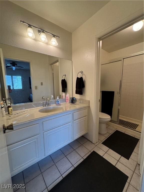 4662 Kelly Barry Way, Las Vegas, NV 89121 - full bathroom with toilet, a stall shower, tile patterned floors, ceiling fan, and vanity