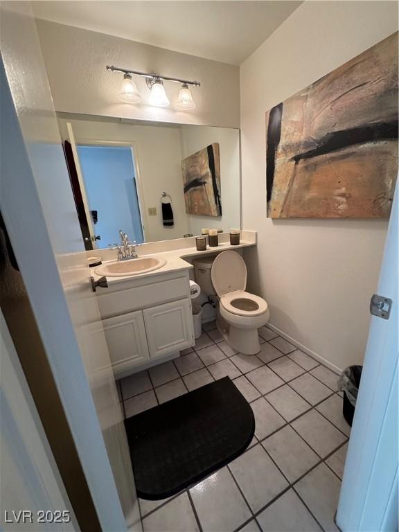 4662 Kelly Barry Way, Las Vegas, NV 89121 - half bath featuring vanity, toilet, and tile patterned floors