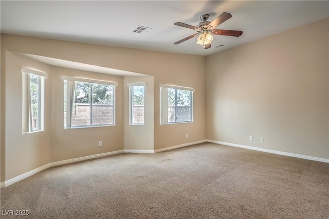 8664 Frasure Falls Ave, Las Vegas, NV 89178 - carpeted spare room with plenty of natural light, baseboards, a ceiling fan, and visible vents