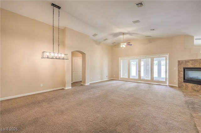 8664 Frasure Falls Ave, Las Vegas, NV 89178 - unfurnished living room with a ceiling fan, visible vents, carpet floors, and high vaulted ceiling