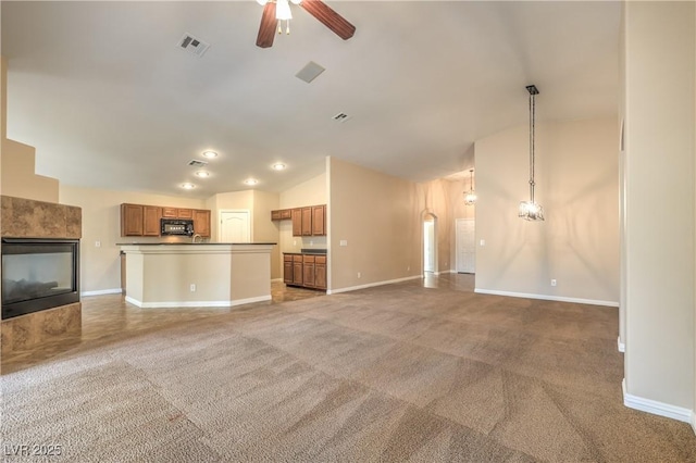 8664 Frasure Falls Ave, Las Vegas, NV 89178 - unfurnished living room with vaulted ceiling, carpet, visible vents, and a ceiling fan