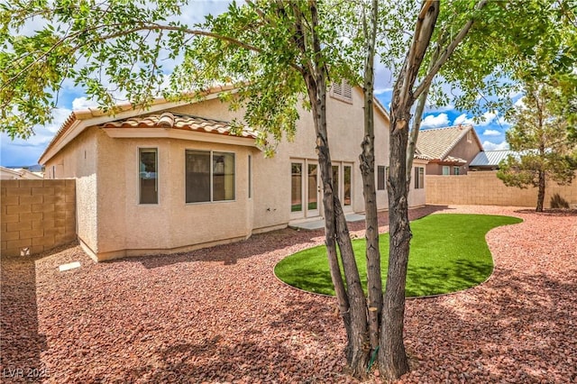 8664 Frasure Falls Ave, Las Vegas, NV 89178 - back of house with a tiled roof, stucco siding, and a fenced backyard