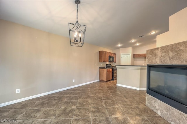 8664 Frasure Falls Ave, Las Vegas, NV 89178 - kitchen featuring lofted ceiling, brown cabinets, black microwave, gas range oven, and baseboards