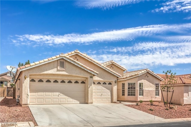 8664 Frasure Falls Ave, Las Vegas, NV 89178 - view of front of home featuring concrete driveway, a garage, stucco siding, and a tiled roof