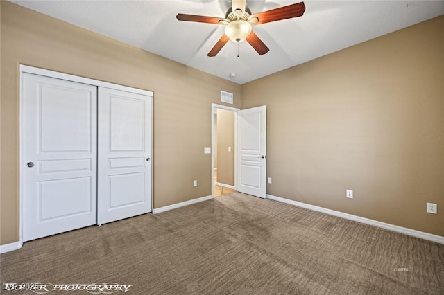 unfurnished bedroom with carpet, a ceiling fan, a closet, visible vents, and baseboards