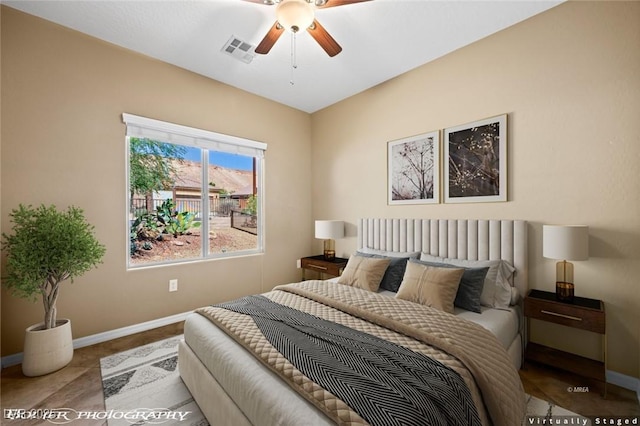 bedroom with visible vents, baseboards, and a ceiling fan