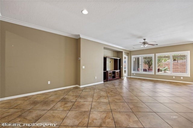 tiled empty room with crown molding, baseboards, and a ceiling fan