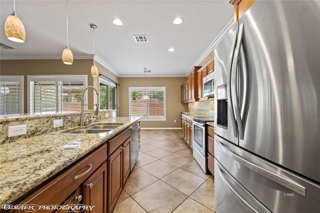 kitchen featuring a sink, brown cabinetry, stainless steel appliances, and visible vents