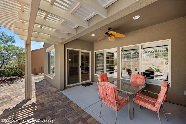 view of patio featuring a pergola, ceiling fan, fence, and outdoor dining space