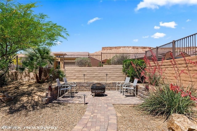 view of yard with an outdoor fire pit, a patio, and a fenced backyard