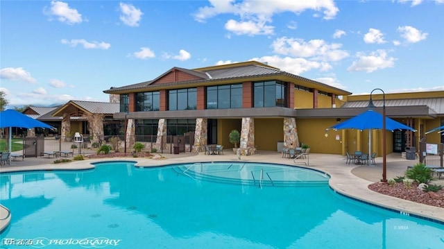 pool featuring a patio area and fence