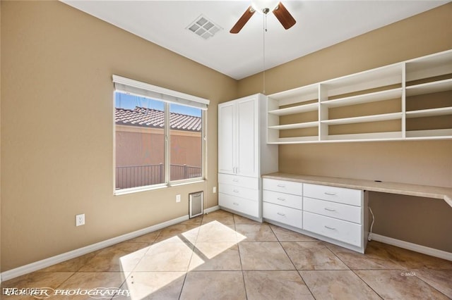 interior space with built in study area, baseboards, and visible vents