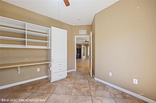 unfurnished bedroom featuring light tile patterned floors, visible vents, and baseboards