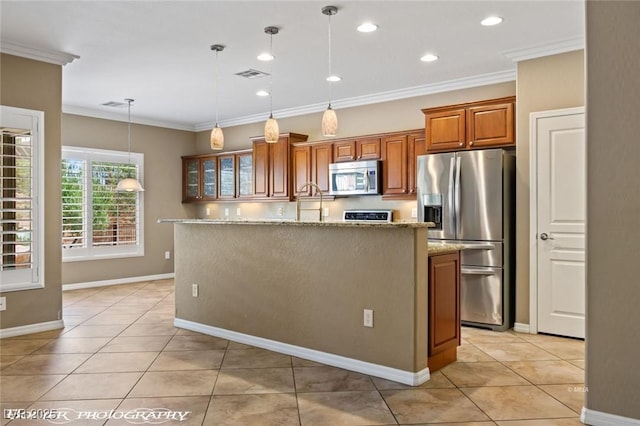 kitchen featuring light tile patterned floors, stainless steel appliances, brown cabinetry, light stone countertops, and ornamental molding