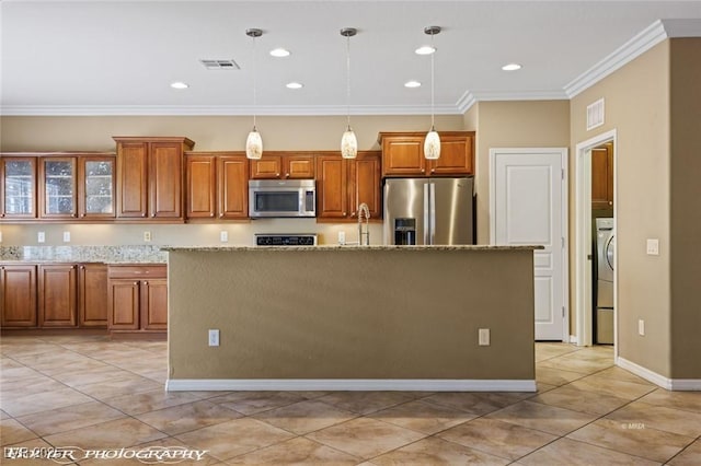 kitchen featuring light tile patterned floors, stainless steel appliances, brown cabinets, and visible vents