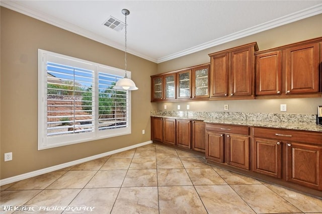 kitchen featuring brown cabinets, decorative light fixtures, visible vents, crown molding, and glass insert cabinets