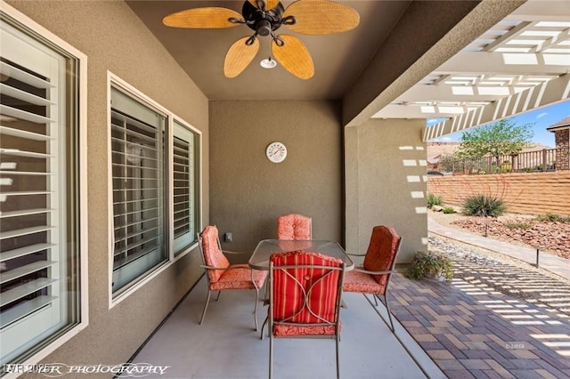 view of patio / terrace with a pergola, fence, outdoor dining space, and a ceiling fan