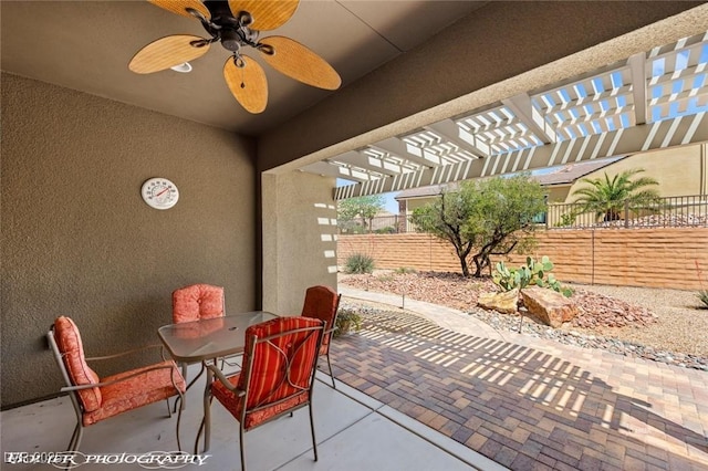 view of patio / terrace featuring a pergola, fence, outdoor dining area, and a ceiling fan