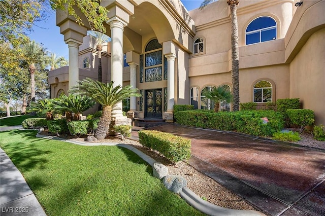 1008 Trophy Hills Dr, Las Vegas, NV 89134 - doorway to property featuring a yard, stucco siding, and french doors