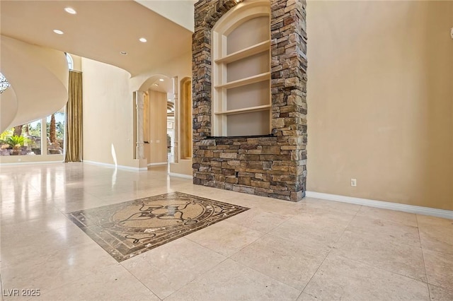 1008 Trophy Hills Dr, Las Vegas, NV 89134 - interior space with a high ceiling, baseboards, arched walkways, and recessed lighting