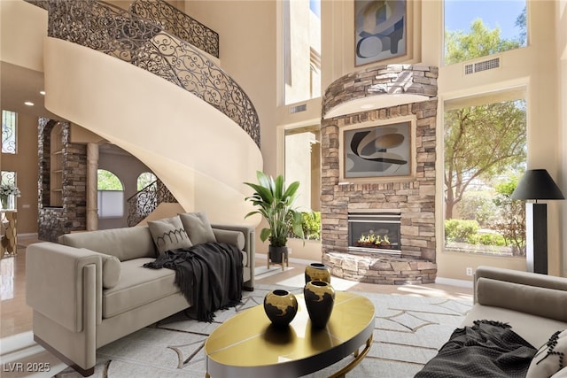 1008 Trophy Hills Dr, Las Vegas, NV 89134 - living room featuring plenty of natural light, visible vents, baseboards, and a towering ceiling