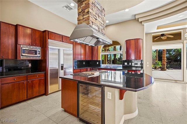 1008 Trophy Hills Dr, Las Vegas, NV 89134 - kitchen featuring built in appliances, visible vents, range hood, beverage cooler, and dark countertops