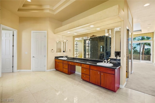 1008 Trophy Hills Dr, Las Vegas, NV 89134 - full bath featuring a tray ceiling, baseboards, decorative columns, a sink, and double vanity